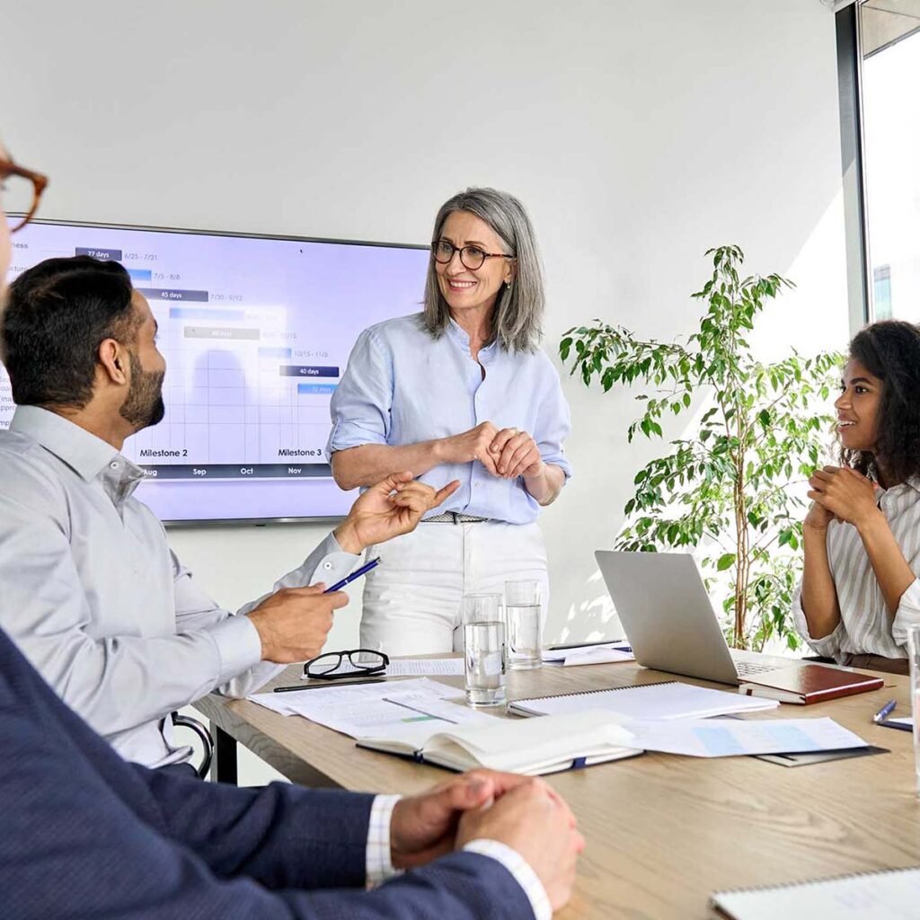 A diverse group of professionals having a meeting in a modern office setting.