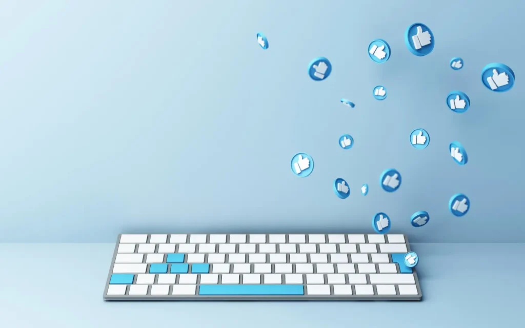 A white keyboard with blue thumbs-up icons floating above.